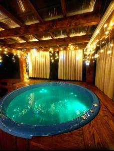 a large jacuzzi tub in a room with lights at DOMEK KARMELOWY - Azyl Na Szwedach in Ruszelczyce