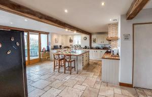 a large kitchen with a large island in a room at Beautiful Home In Armillac With House A Panoramic View in Armillac
