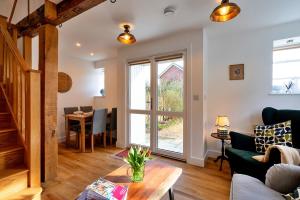 a living room with a couch and a table at Finest Retreats - Chilton Cottage in Hungerford