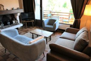 ein Wohnzimmer mit Sofas und Stühlen sowie einem TV in der Unterkunft Résidence La Gelinotte - 3 Pièces pour 6 Personnes 60 in Saint-Gervais-les-Bains