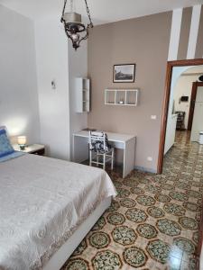 a bedroom with a bed and a desk and a mirror at Аppartamenti vicino al mare in Scalea