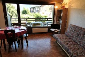 uma sala de estar com uma mesa e um sofá em Résidence La Gelinotte - Studio pour 4 Personnes 92 em Saint-Gervais-les-Bains