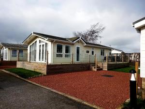 a white house with a yard in front of it at 19 Park Views Just outside Penrith for Holidays and Short Breaks please no commercial vans thankyou in High Hesket