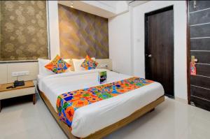 a bedroom with a large bed in a room at ESTA EXPRESS,VIMAN NAGAR in Pune