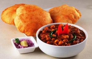 a plate of food with a bowl of beans and bread at ESTA EXPRESS,VIMAN NAGAR in Pune
