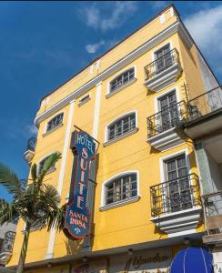 a yellow building with a hotel sign on it at Hotel Suite Santa Rosa in Santa Rosa de Cabal