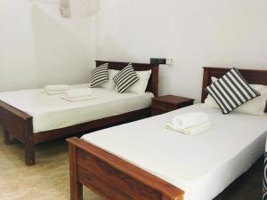 Letto o letti in una camera di Dimuthu Green Villa