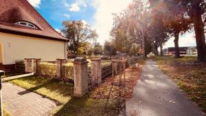 a path next to a fence next to a house at Quartier Alte Schule Breese in Breese