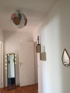 a room with a hallway with a door and a mirror at Cosy large appartement 20 minutes downtown Paris in Villejuif
