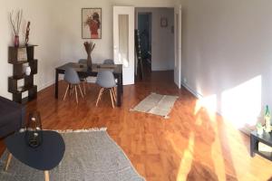 a living room with a table and a dining room at Cosy large appartement 20 minutes downtown Paris in Villejuif
