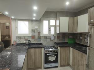 a kitchen with a stove and a sink in it at المعمورة الشاطئ بالاسكندرية شارع سيف وانلي in Alexandria