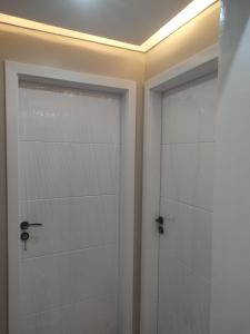 a bathroom with two white doors and a ceiling at المعمورة الشاطئ بالاسكندرية شارع سيف وانلي in Alexandria