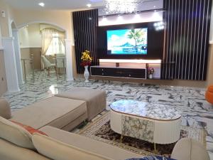 a living room with a tv and a couch at IMSMART Luxury Homes in Uyo