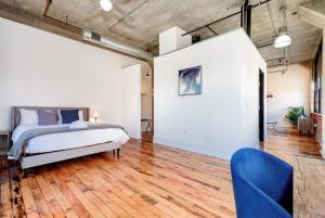 a bedroom with a bed and a wooden floor at Sleeps 3 Stunning 1BR by CozySuites in Saint Louis