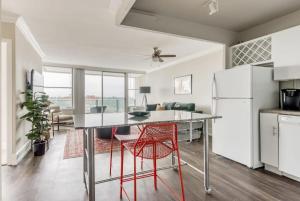 a kitchen with a table and a red chair at CozySuites 800 Tower 1BR w sky pool, gym! 05 in Louisville