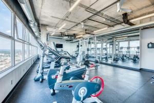 a gym with cardio machines and treadmills at CozySuites 800 Tower 1BR w sky pool, gym! 24 in Louisville