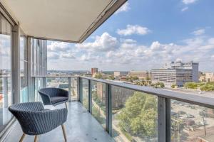 a balcony with two chairs and a view of the city at CozySuites 800 Tower 1BR w sky pool, gym! 14 in Louisville