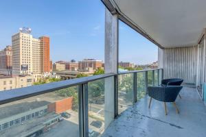 a chair on a balcony with a view of a city at CozySuites 800 Tower 1BR w sky pool, gym! 12 in Louisville