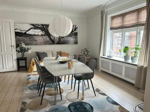 a dining room with a white table and chairs at Boutique-Aalborg-Free parking - Citycenter in Aalborg
