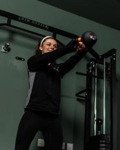 a woman holding a barbell in a gym at The Dashwood in Kirtlington