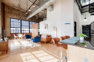 an industrial loft with a living room and dining area at TWO Stunning Adler Loft by CozySuites in Saint Louis