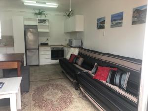 a living room with a couch and a kitchen at Shearwater 106 in Sedgefield
