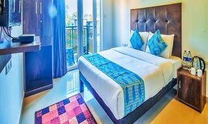 a bedroom with a large bed and a balcony at Balaji inn Baga in Baga