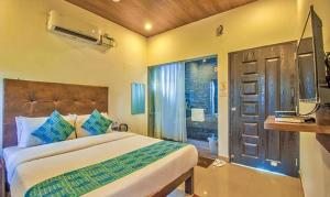 a bedroom with a bed and a window and a door at Balaji inn Baga in Baga
