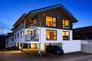 a house with a car parked in front of it at Berg Fux - Ferienwohnung Francis der Esel in Sonthofen
