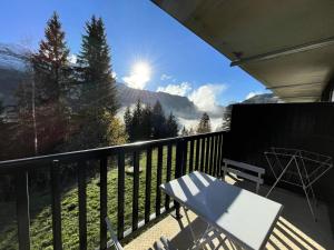 a balcony with a table and a view of a mountain at Résidence Pollux - Studio pour 4 Personnes 15 in Flaine