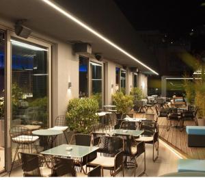 a group of tables and chairs on a patio at Sunset Apartment in Vlorë