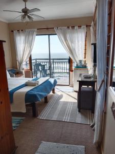 a bedroom with a bed and a view of the ocean at Bayview Guest House in Amanzimtoti