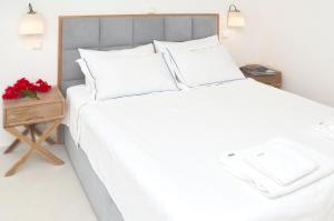 A bed or beds in a room at Keros Art Hotel