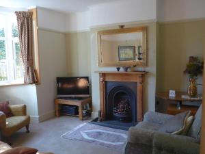 a living room with a fireplace and a television at Home from Home 