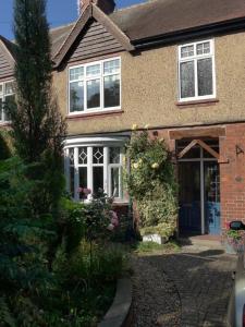 a brick house with a front door and a driveway at Home from Home 