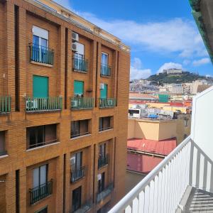 an apartment building with balconies on a balcony at Hotel Bella Capri in Naples