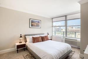 a bedroom with a bed and a large window at TWO 800 Tower CozySuites w skypool lounge 8FL in Louisville