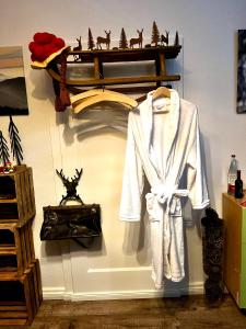 a white robe is hanging on a wall at Touchdown21 in Karlsruhe