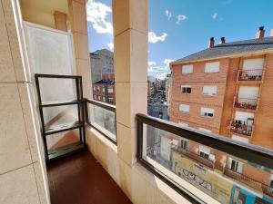 an apartment balcony with a view of a city at Dúplex Valle del Silencio in Ponferrada