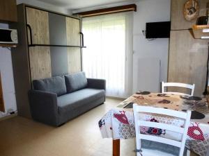 a living room with a couch and a table at Résidence Neouvielle - Beau studio dans le centre de Barèges MAE-8484 in Barèges