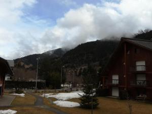 a view of a mountain with clouds in the sky at Résidence Combettes - Studio pour 4 Personnes 34 in Les Contamines-Montjoie