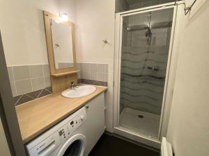 a bathroom with a sink and a washing machine at Résidence Bois De Marie - 3 Pièces pour 5 Personnes 644 in Barèges