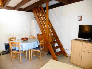 a kitchen with a table with chairs and a staircase at Résidence Neouvielle - Studio duplex avec place de parking dans le centre de Barèges MAE-8714 in Barèges