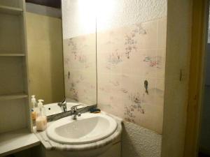 a bathroom with a sink and a mirror at Résidence Neouvielle - Studio duplex avec place de parking dans le centre de Barèges MAE-8714 in Barèges +4 photos