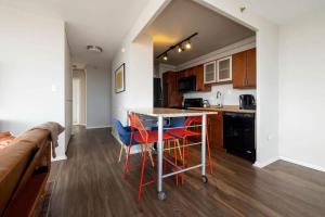 a kitchen with red chairs and a table in it at CozySuites 800 Tower 2BR with sky pool gym 33 in Louisville