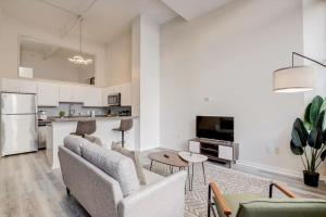 a living room with a couch and a table at CozySuites - 1BR with Direct Skybridge Access #2 in Indianapolis