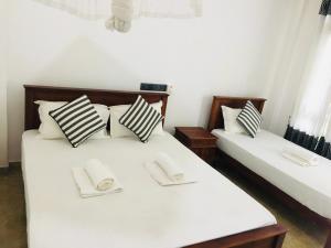 Letto o letti in una camera di Dimuthu Green Villa