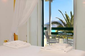 A bed or beds in a room at Keros Art Hotel