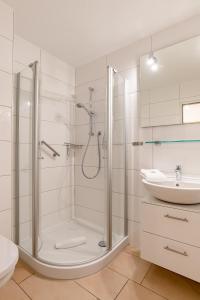 a bathroom with a shower and a sink at Nordland Appartements Wohnung Jütland in Wyk auf Föhr