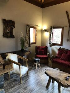 a living room with a couch and a table at Chalet Colenfrey - Chalets pour 10 Personnes 14 in Valloire